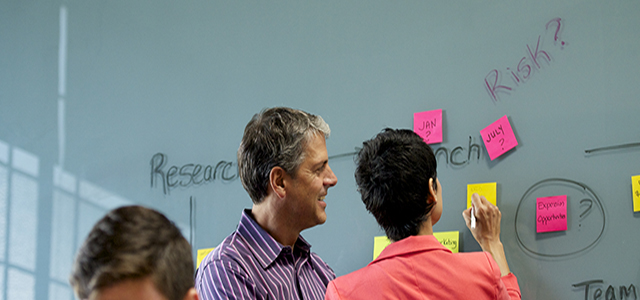 People reviewing plans during a meeting